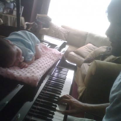 An archival family photo at the piano