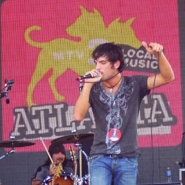 Topher singing on an outdoor stage